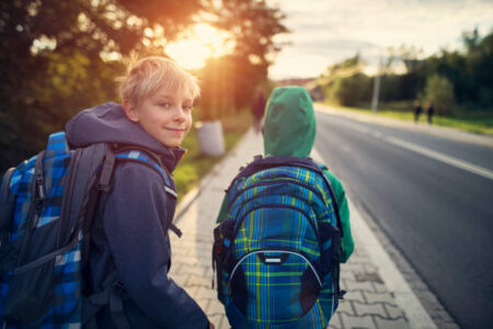 Two school boys walking on sidewalk on way to school. Sunny day morning.
Shot with Nikon D850